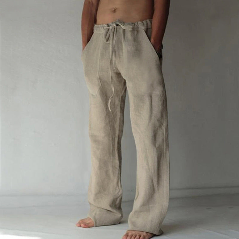 Person wearing beige linen pants against a plain background