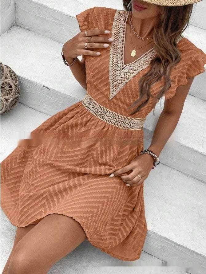 Woman in a chic brown short-sleeve summer dress with lace trim, sitting on steps
