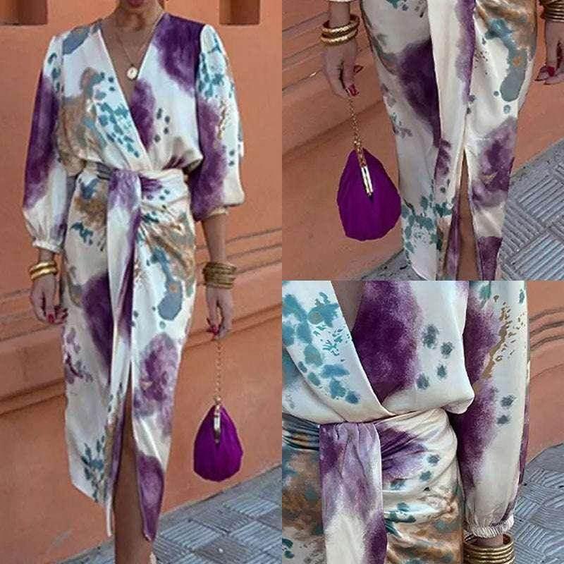 Woman wearing a long-sleeve tie-dye wrap dress with purple, blue, and gold accents, holding a purple handbag.