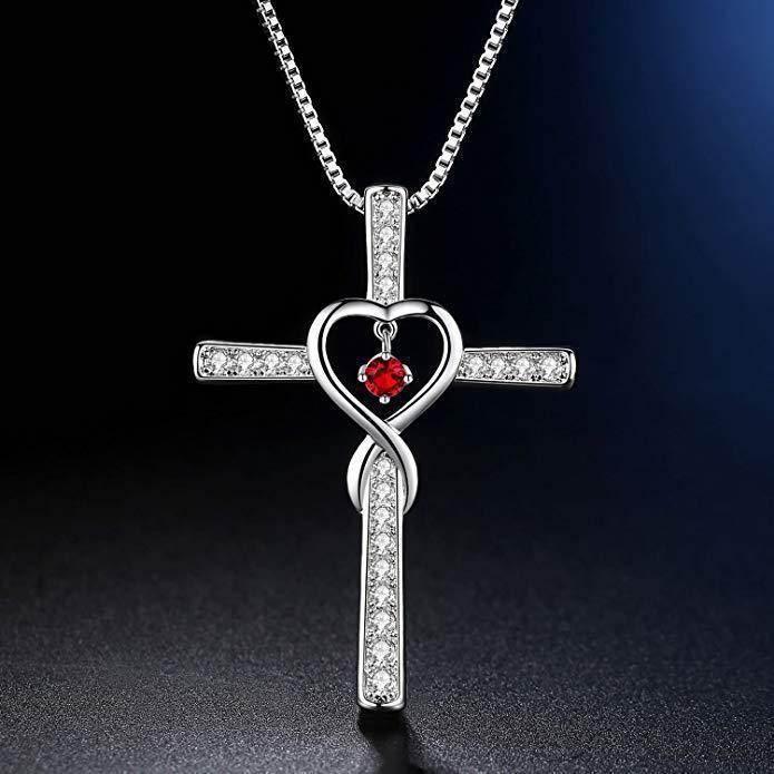 Silver cross pendant necklace with sparkling crystals, heart design, and red gemstone accent
