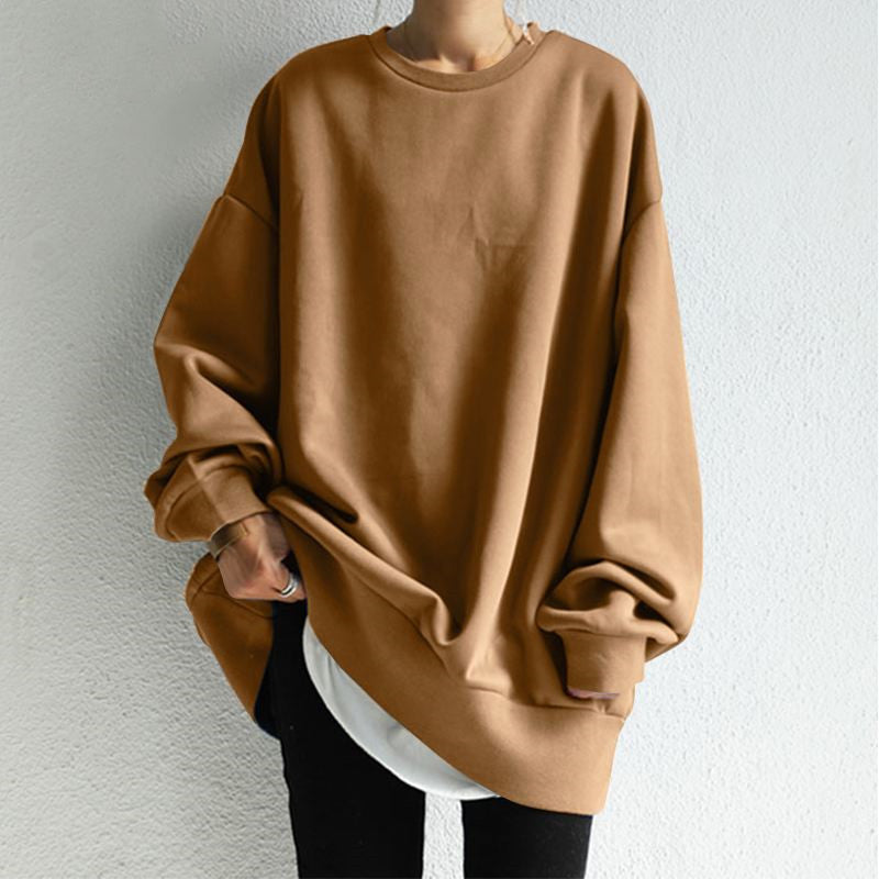 Brown oversized sweatshirt worn by a person on a light gray background
