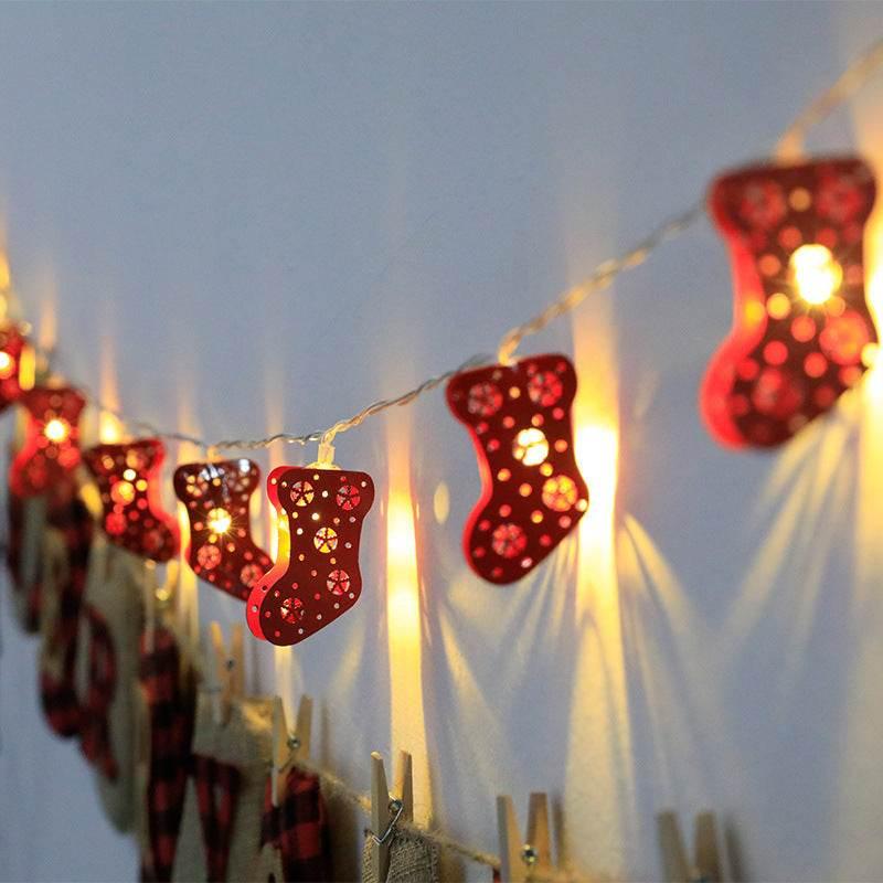 String of red Christmas stocking LED fairy lights hanging on a wall, festive holiday decor