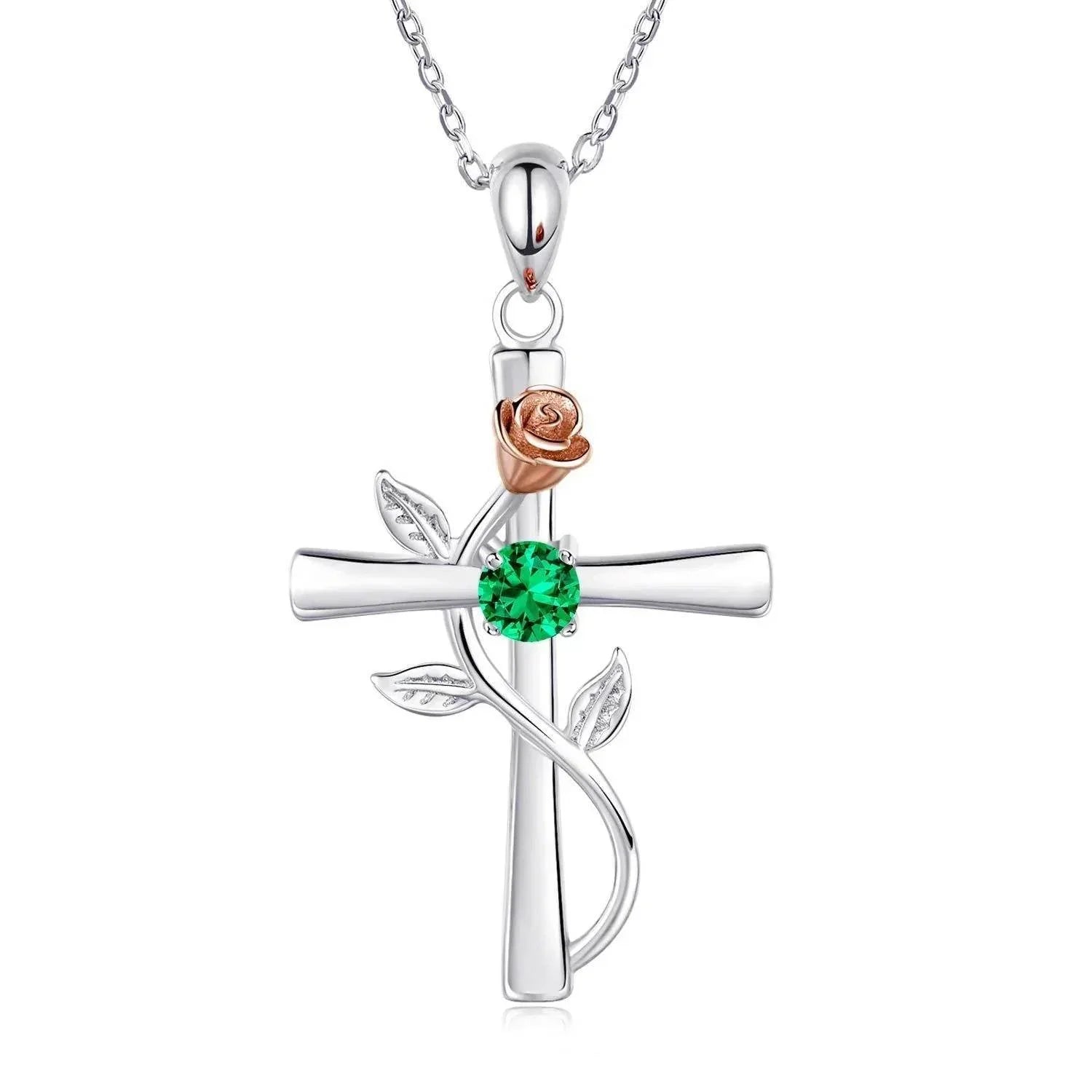 Silver cross pendant necklace with rose gold flower, green gemstone, and leaf accents