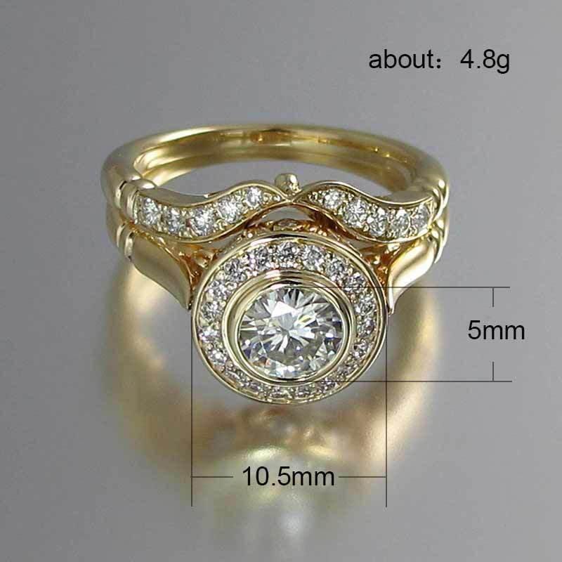 Gold engagement ring set with round cut center stone, halo and pavé band, 10.5mm wide, 5mm tall.