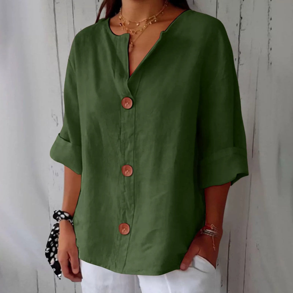 Person wearing a green button-up shirt with a white background
