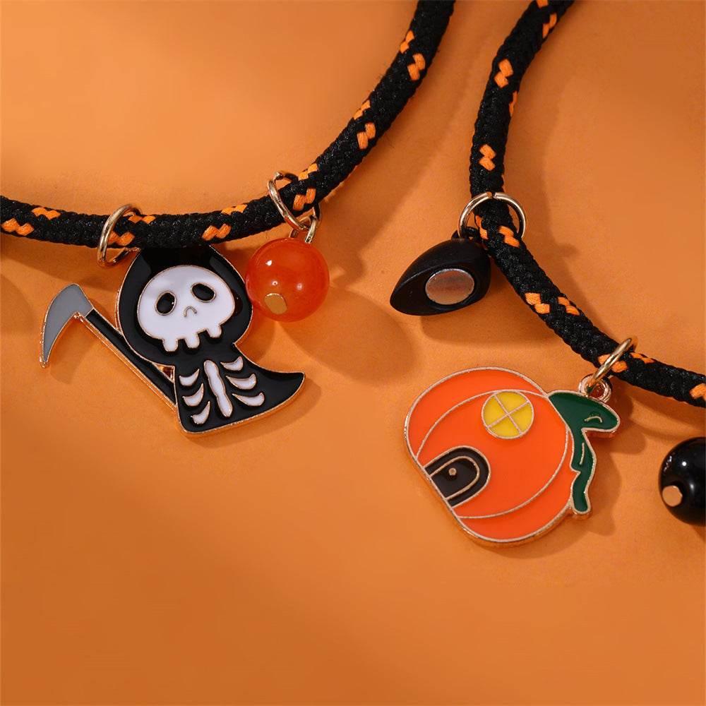 Halloween-themed charm bracelets with pumpkin, skull reaper, and eye pendants on orange background