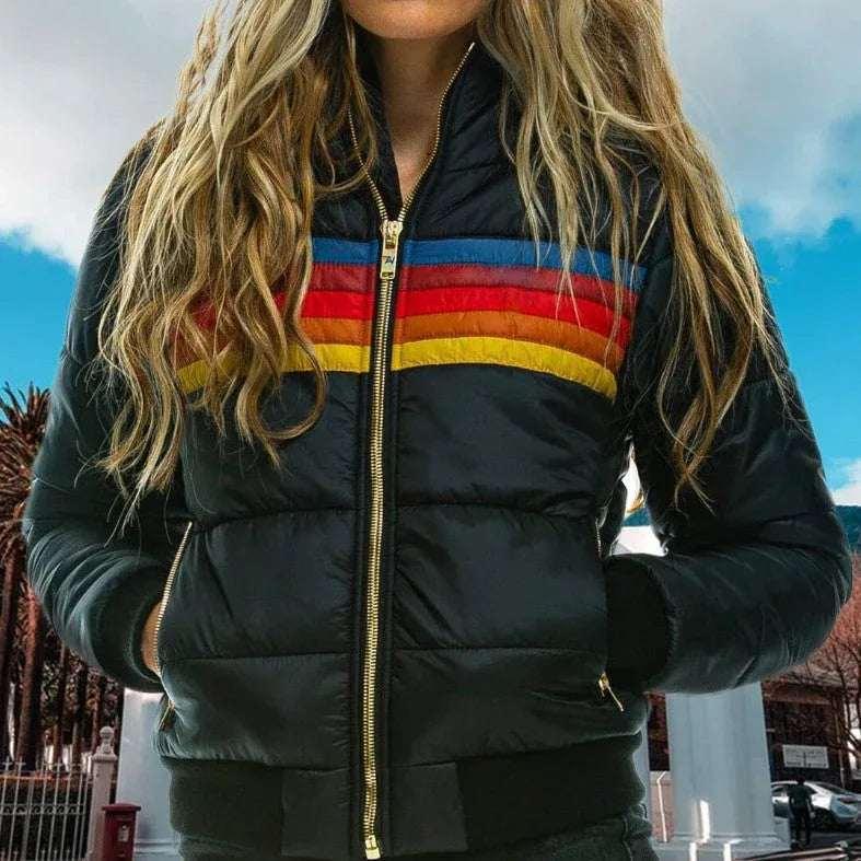 Woman wearing a black puffer jacket with colorful rainbow stripes outdoors