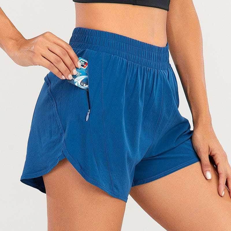 Woman wearing blue athletic shorts with zip pocket, storing gum, activewear fashion