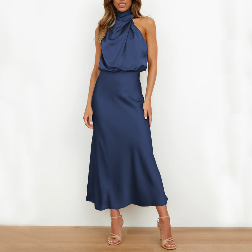 Woman wearing a blue halter neck dress against a white background