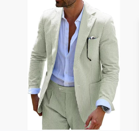 Man wearing a light green pinstripe suit with a white shirt on a white background