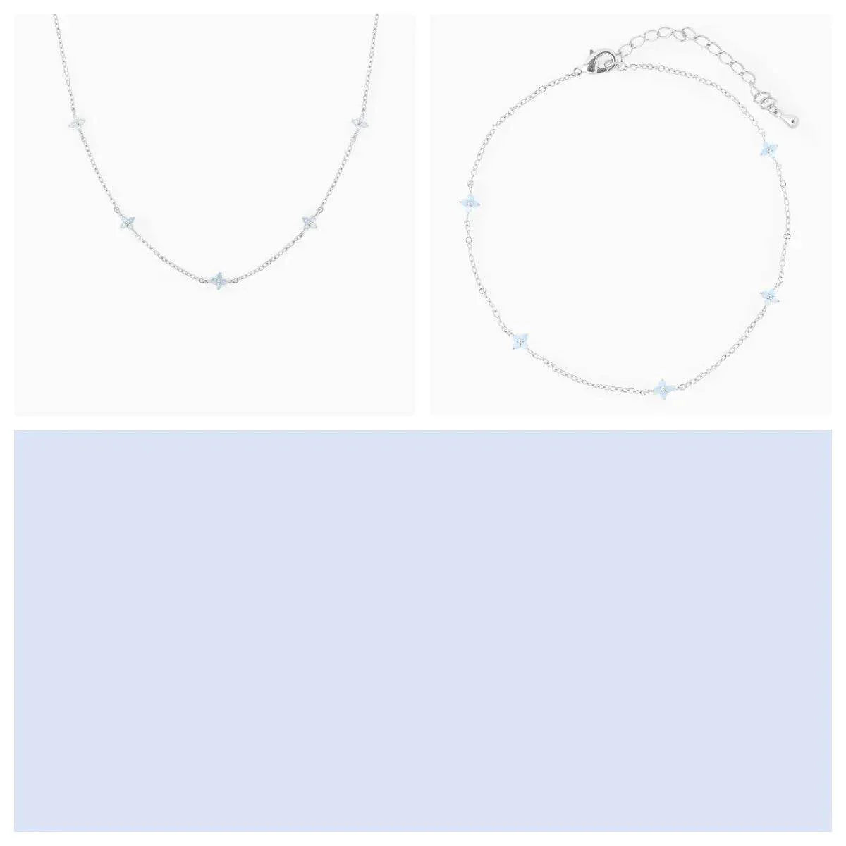 Delicate silver star necklace and bracelet jewelry set on a white background