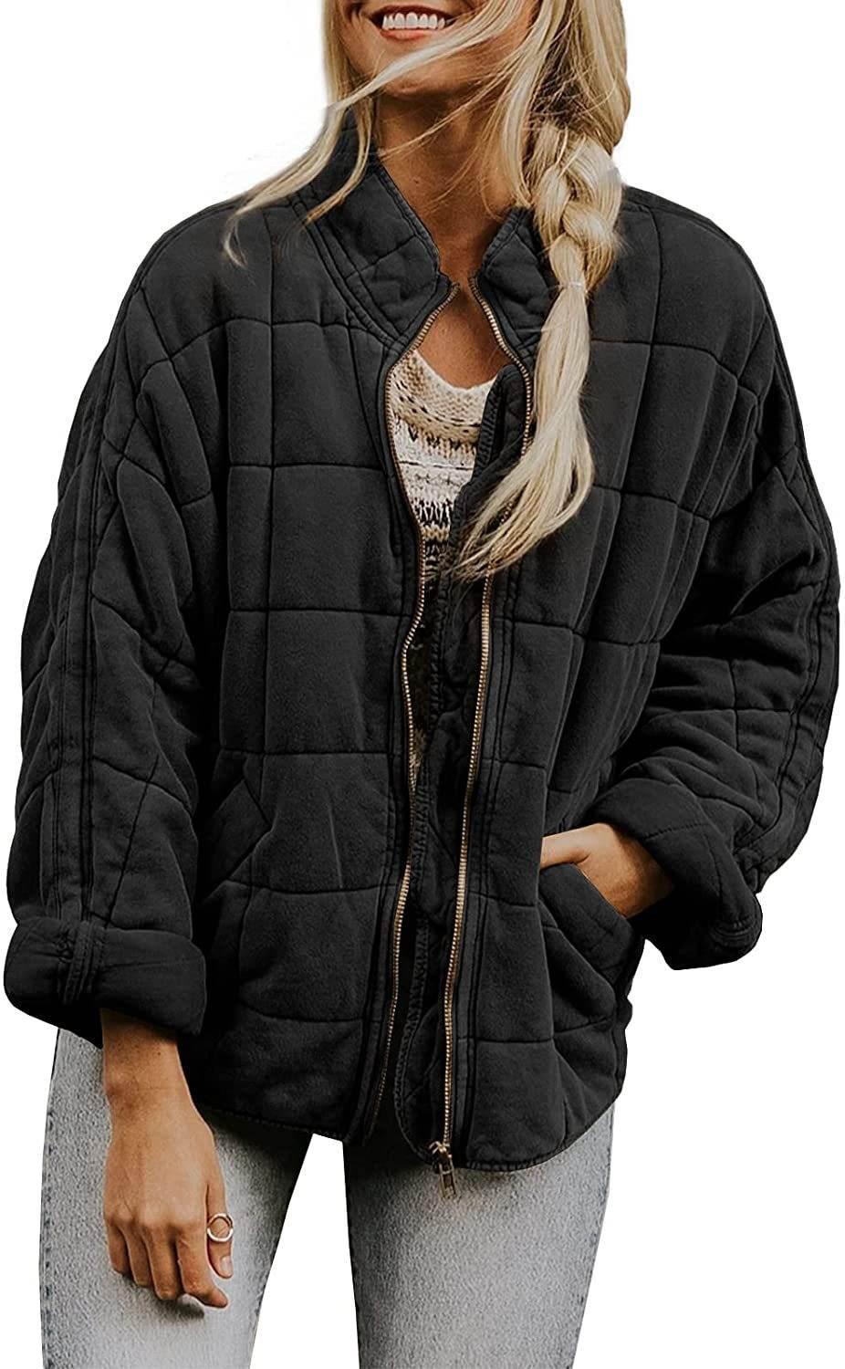 Woman wearing a black quilted oversized zip-up jacket, casual sweater and light jeans