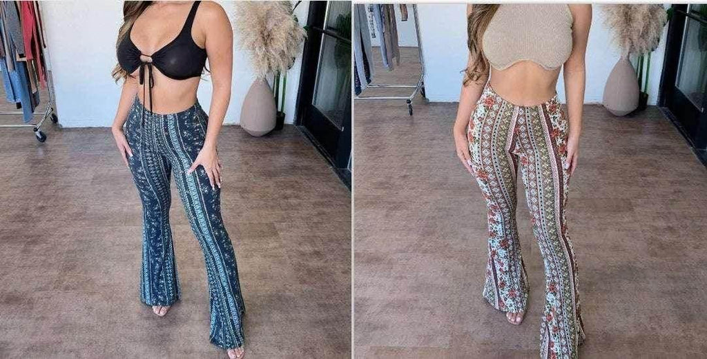 Two women modeling high-waisted patterned flare pants in trendy indoor setting