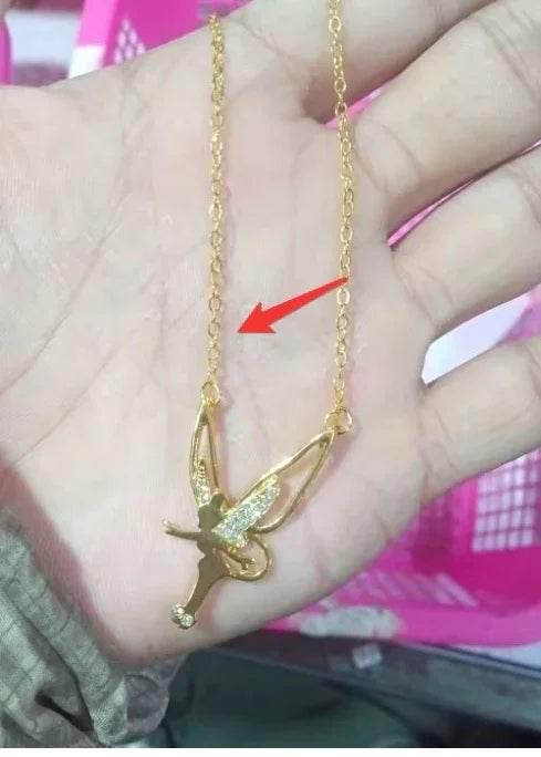 Gold fairy pendant necklace with crystal accents held in hand, women's trendy jewelry