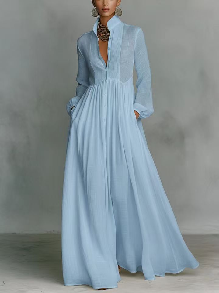 Light blue dress with long sleeves and a high neckline on a plain background