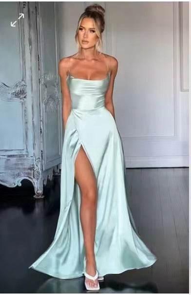 Woman in a light blue satin evening gown with spaghetti straps and high slit, elegant fashion