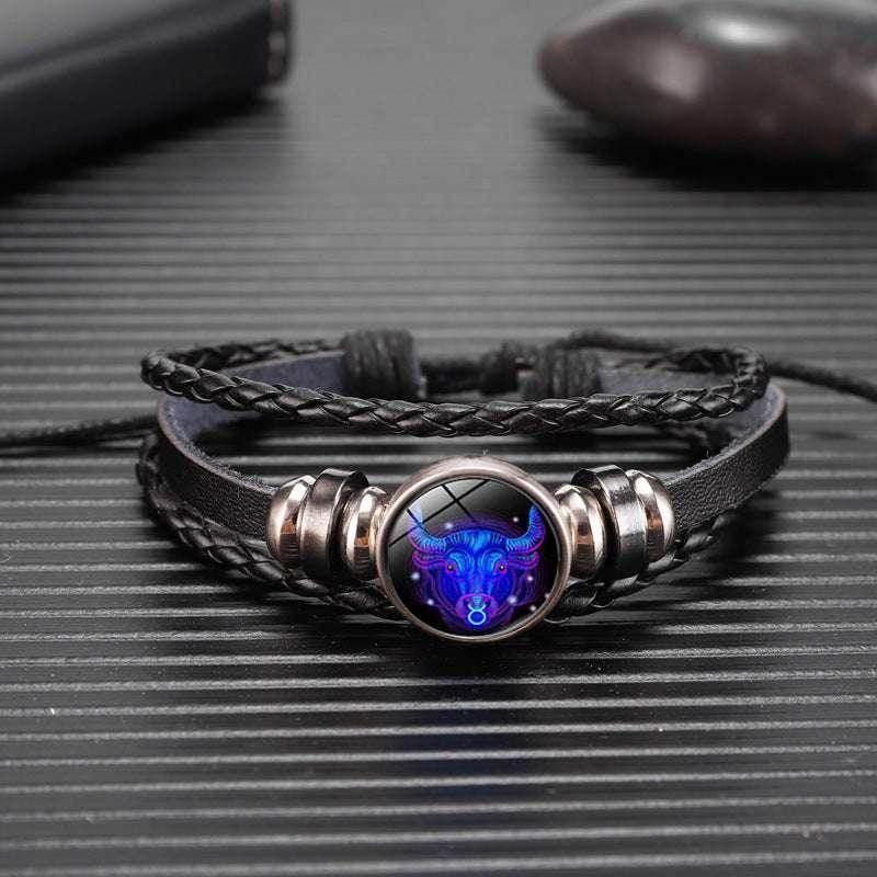 Black braided leather bracelet with glowing bull zodiac charm, stylish men's accessory