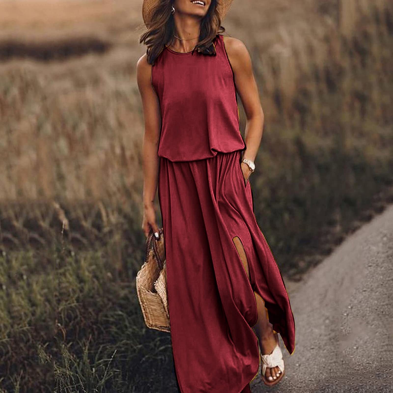 Woman in a red dress walking on a path with a field in the background