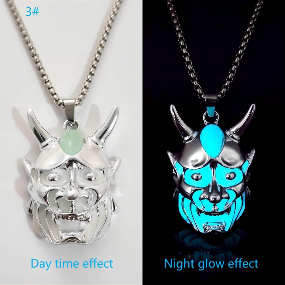 Silver demon mask pendant necklace with glow-in-the-dark blue accents, shown in day and night.