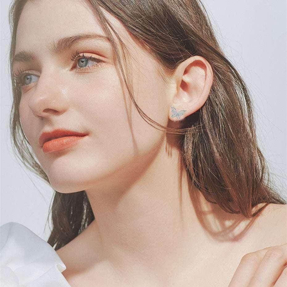 Woman wearing butterfly stud earrings, trendy fashion jewelry for women
