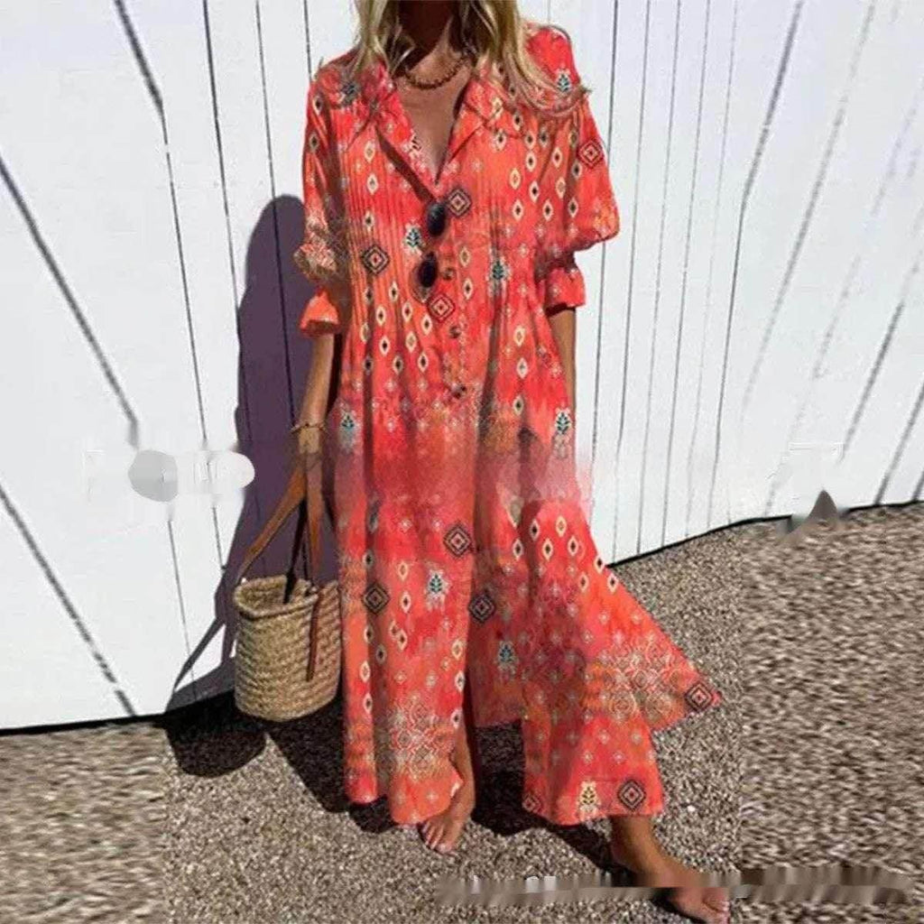 Woman in a vibrant boho orange maxi dress with geometric patterns and straw bag outdoors