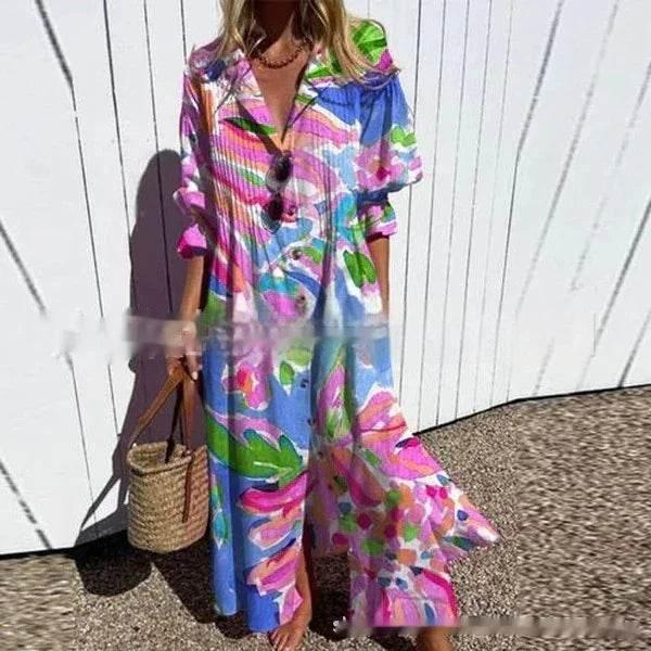 Woman wearing colorful floral maxi dress with wide sleeves, holding straw handbag outdoors