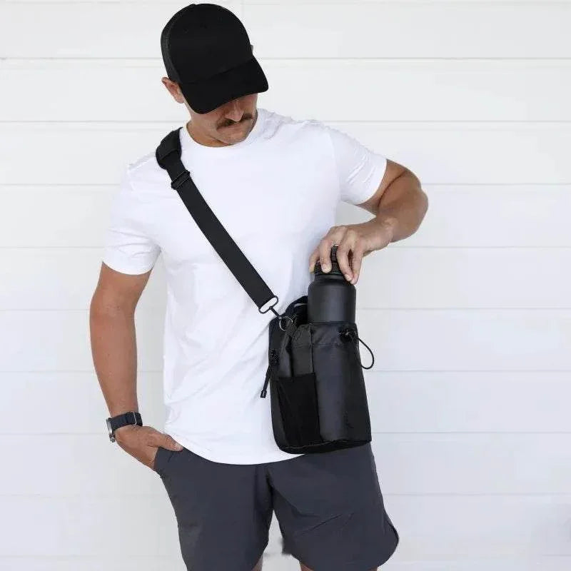 Man in casual outfit with black crossbody bag and water bottle against white background