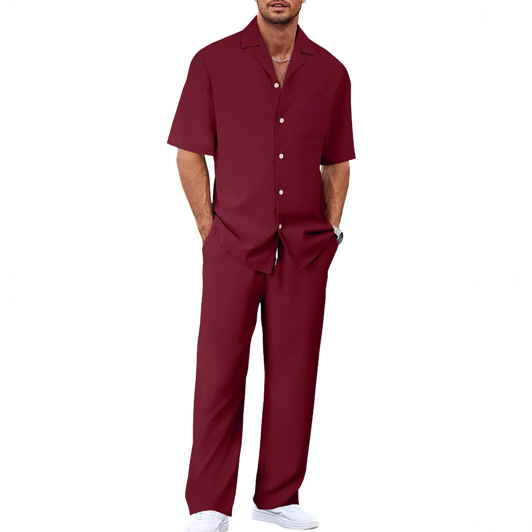 Man wearing a maroon shirt and pants set on a white background