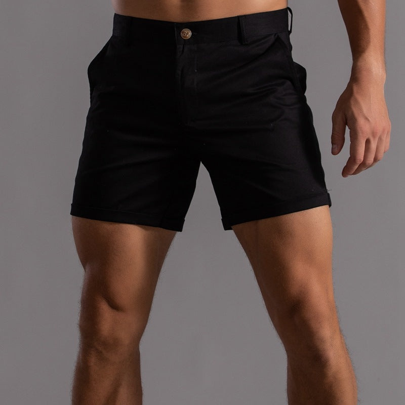 Black shorts worn by a person on a gray background