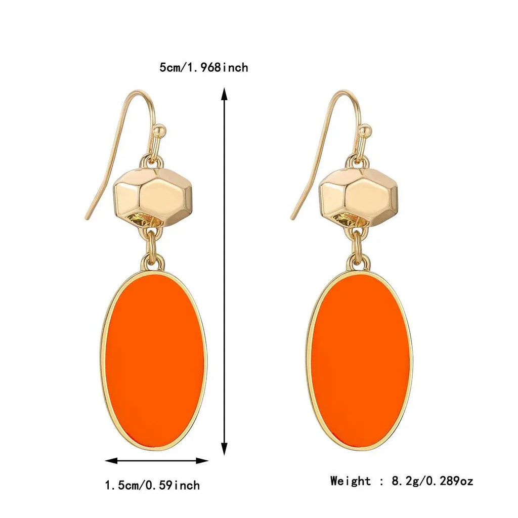 Gold drop earrings with orange oval pendant, geometric accent, and size measurements.