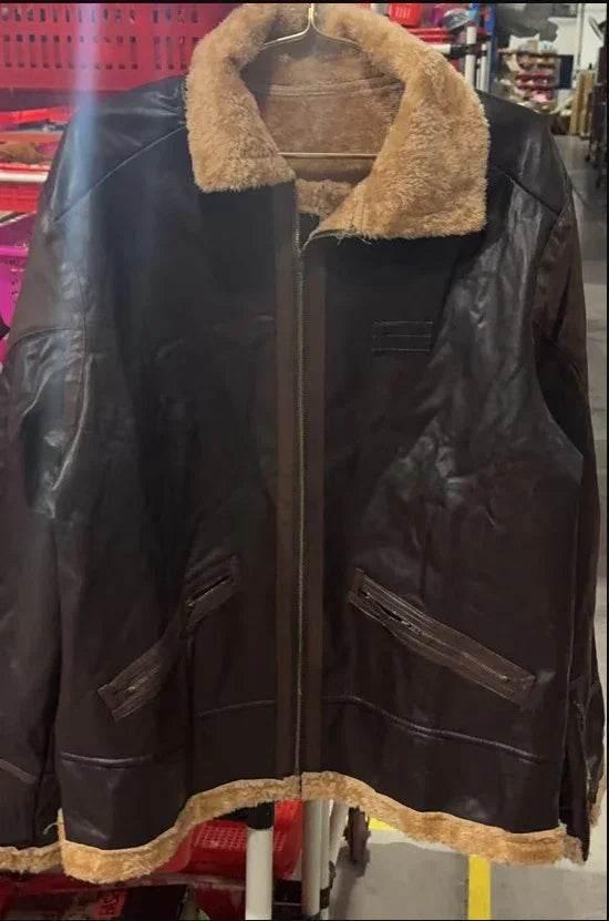 Brown faux leather jacket with tan shearling collar and trim, hanging on a rack indoors