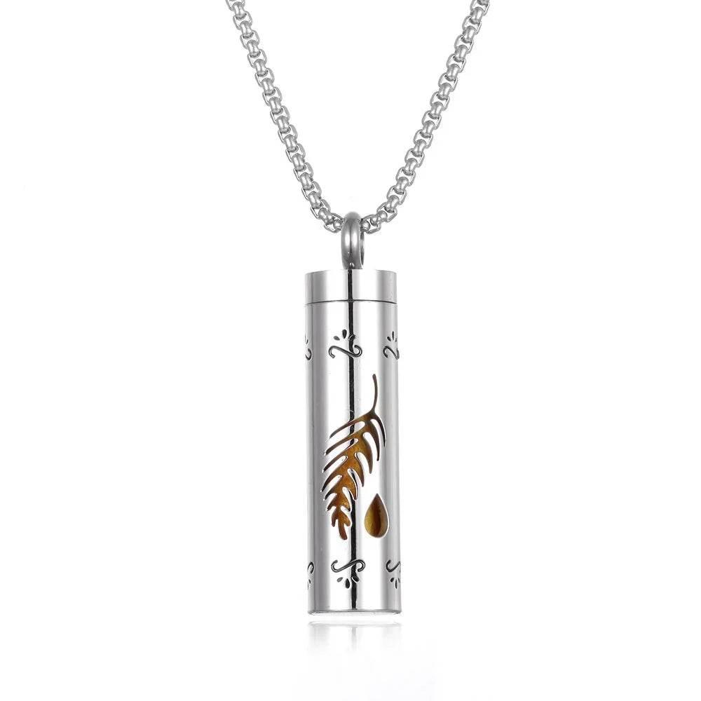 Silver cylindrical pendant necklace with feather and teardrop cutout design on white background