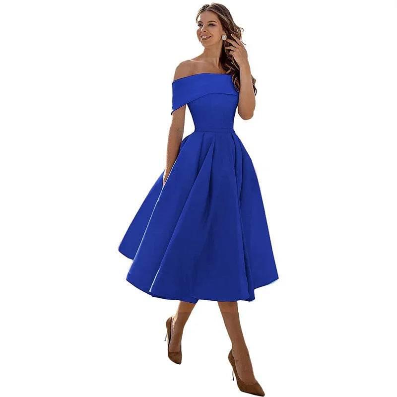 Woman modeling elegant royal blue off-shoulder midi dress and heels
