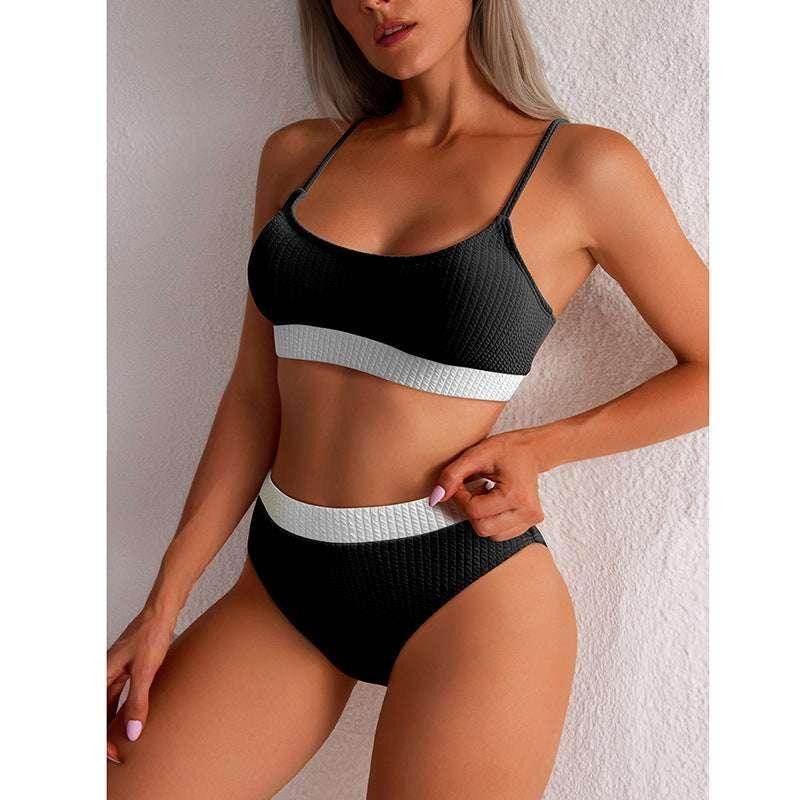 Woman wearing a black textured bikini set with white trim, trendy swimwear fashion