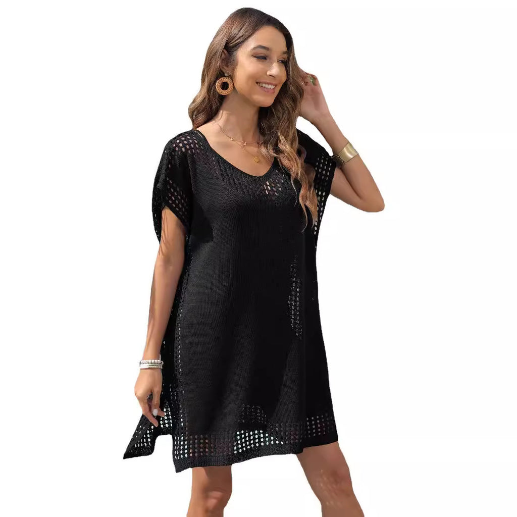 Woman wearing a black dress with cut-out details on a white background