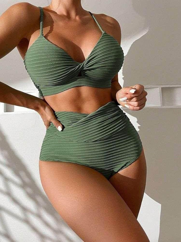 Woman wearing a ribbed green high-waisted bikini set, trendy swimwear in sunlight