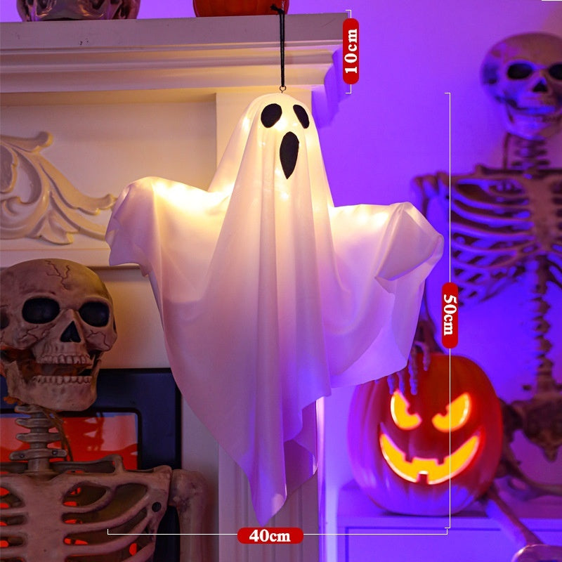 Halloween-themed decoration with ghost, pumpkins, and skeletons on a purple background.