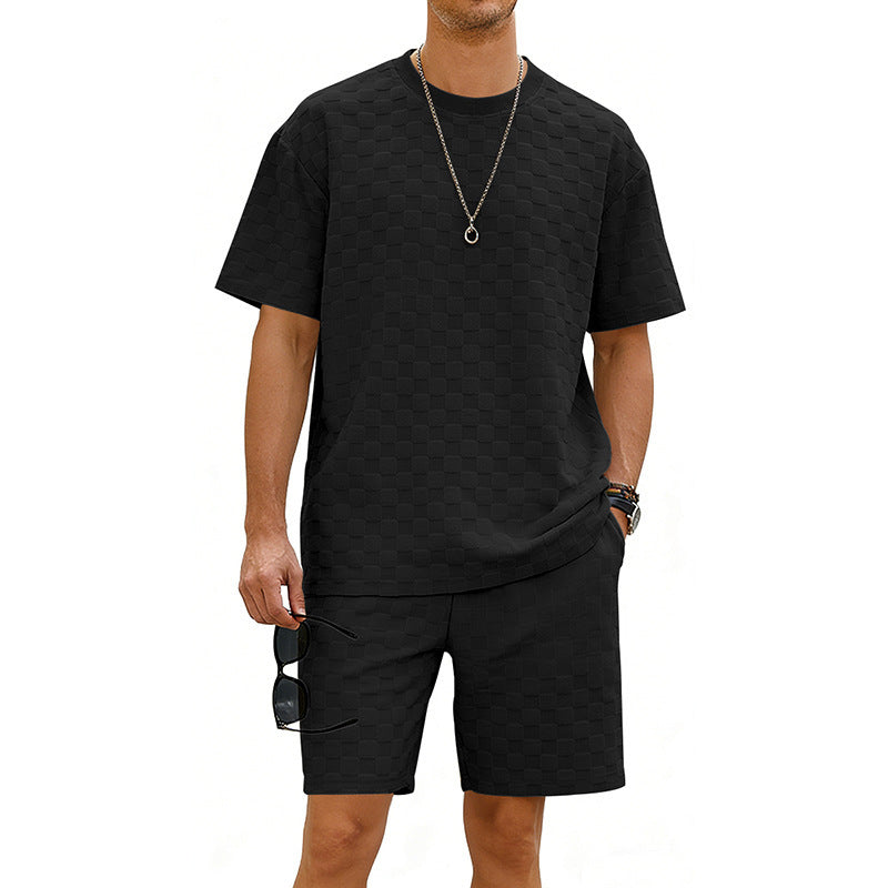 Person wearing a black t-shirt and shorts set on a white background