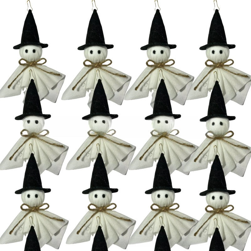 A set of small witch-shaped hanging ornaments arranged in a grid on a plain white background. Each ornament has a black pointed hat, a white body, black facial features, and a tan rope bow.