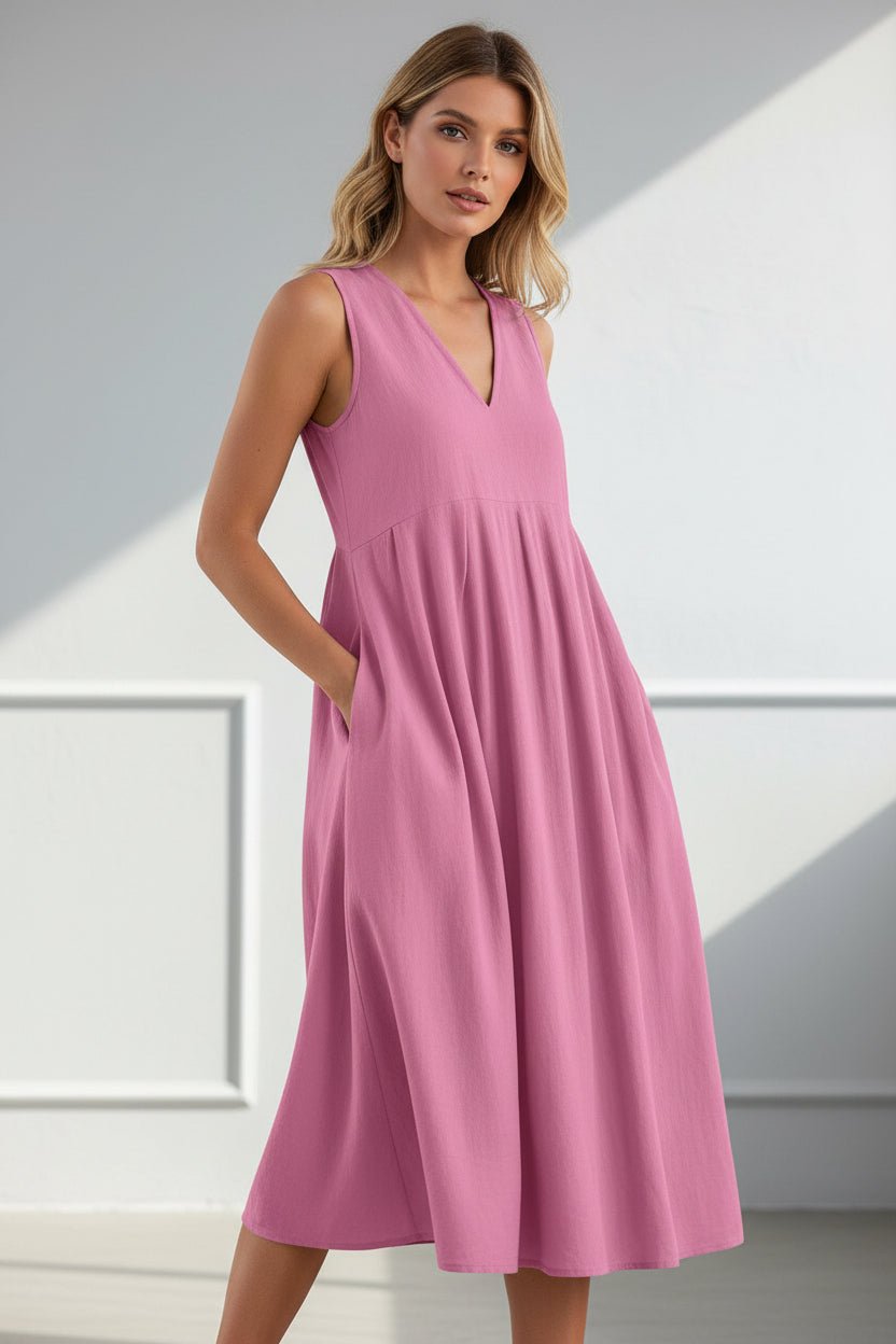 Pink sleeveless dress worn by a person on a white background