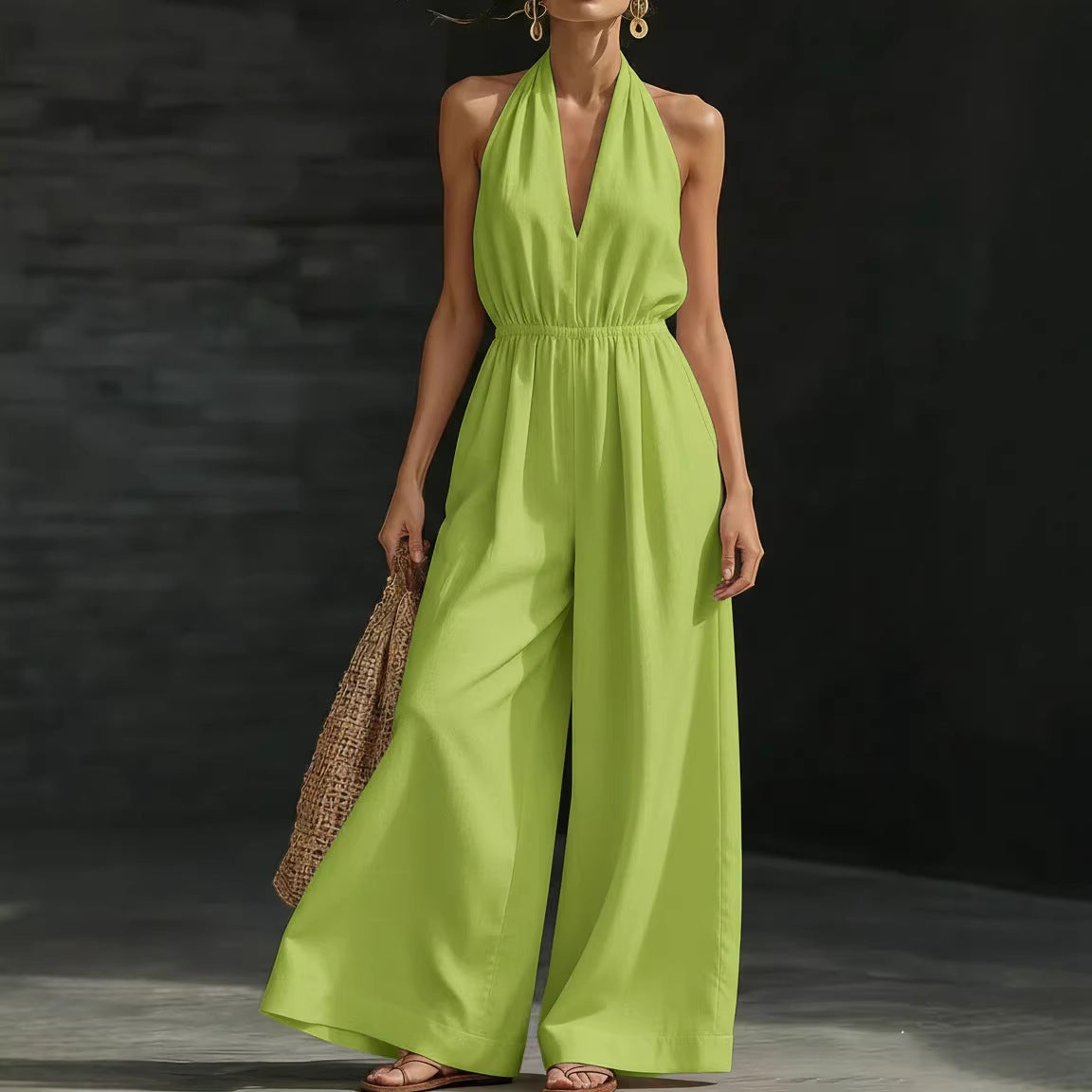 Woman wearing a bright green jumpsuit against a dark background
