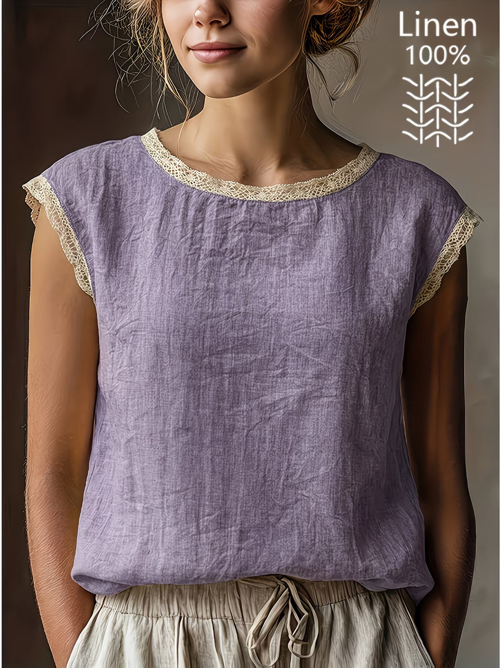 Woman wearing a purple linen top with lace trim on a plain background