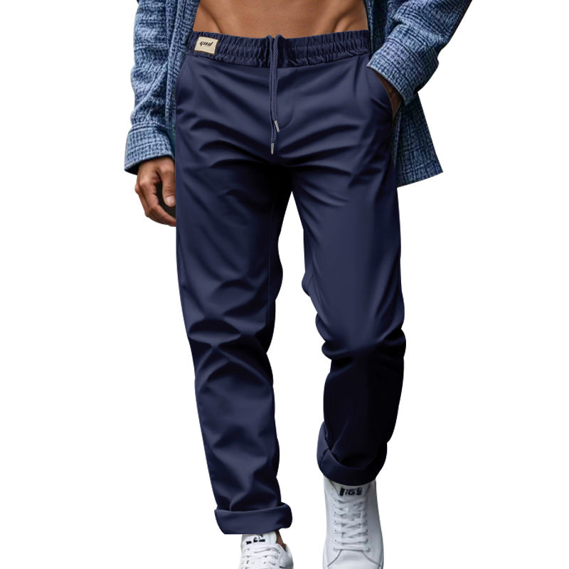Navy blue pants worn by a person on a white background