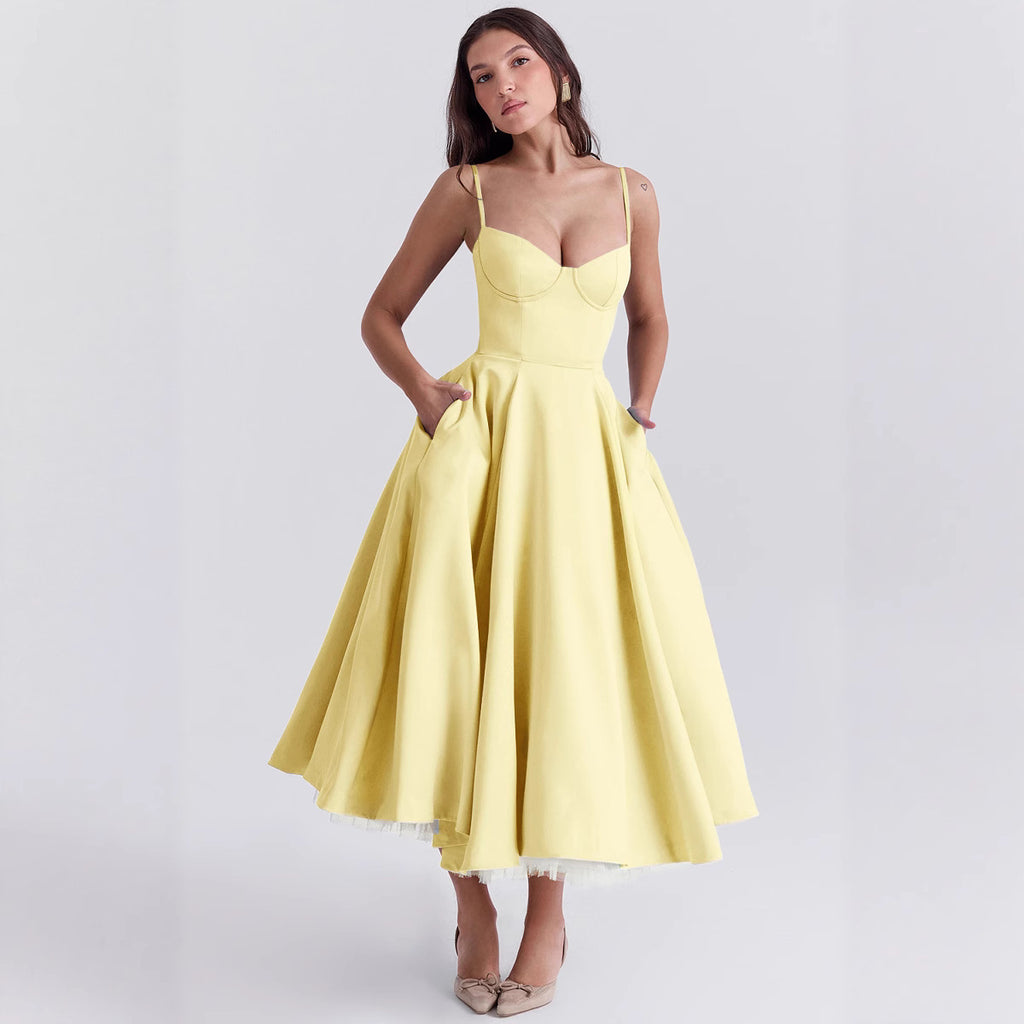 Woman wearing a yellow dress on a light gray background