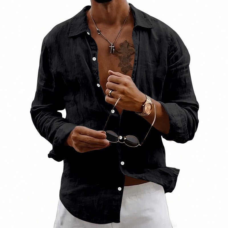 Man wearing a black shirt holding sunglasses with a white background
