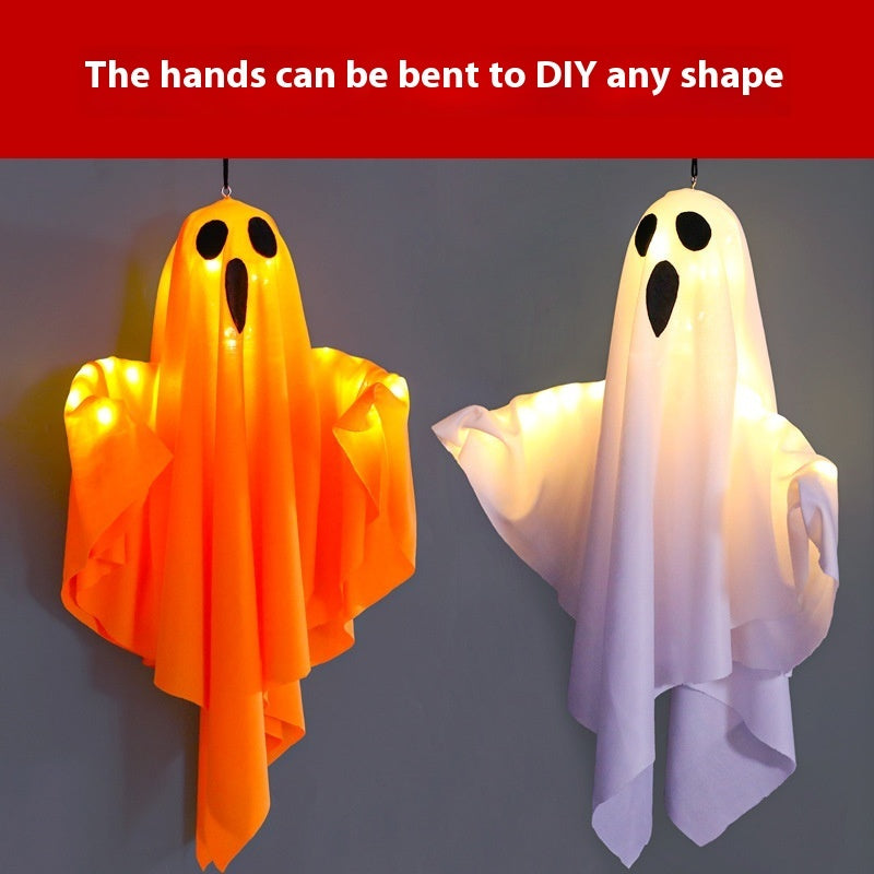 Two ghost-shaped decorations, one orange and one white, with bendable arms on a gray background.
