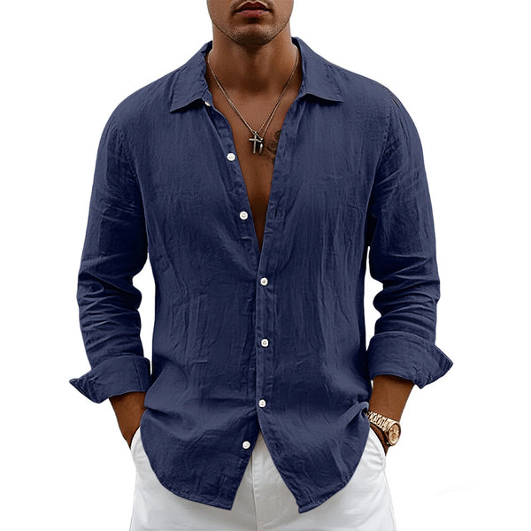 Man wearing a blue button-up shirt with rolled-up sleeves on a white background