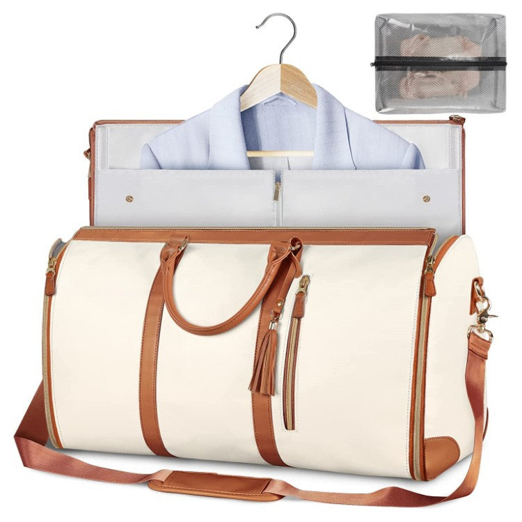 White duffel bag with brown straps and a garment on a hanger inside, on a white background.