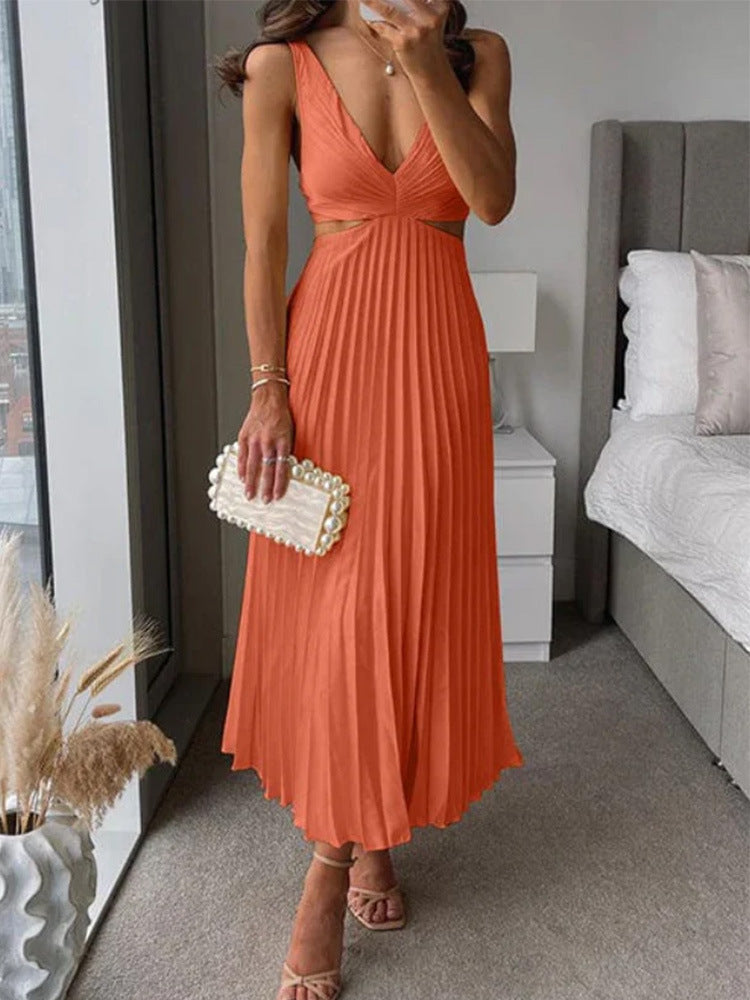 Woman in an orange dress holding a clutch in a bedroom setting