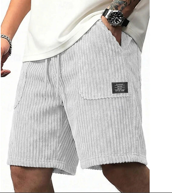 Light gray corduroy shorts with a patch on a white background